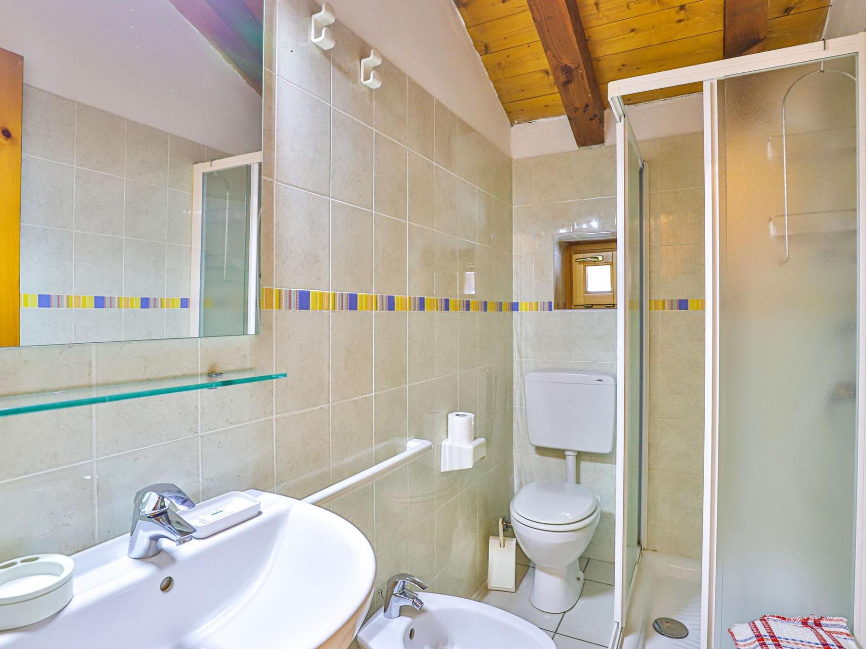 A bathroom with a sink, toilet, and shower.