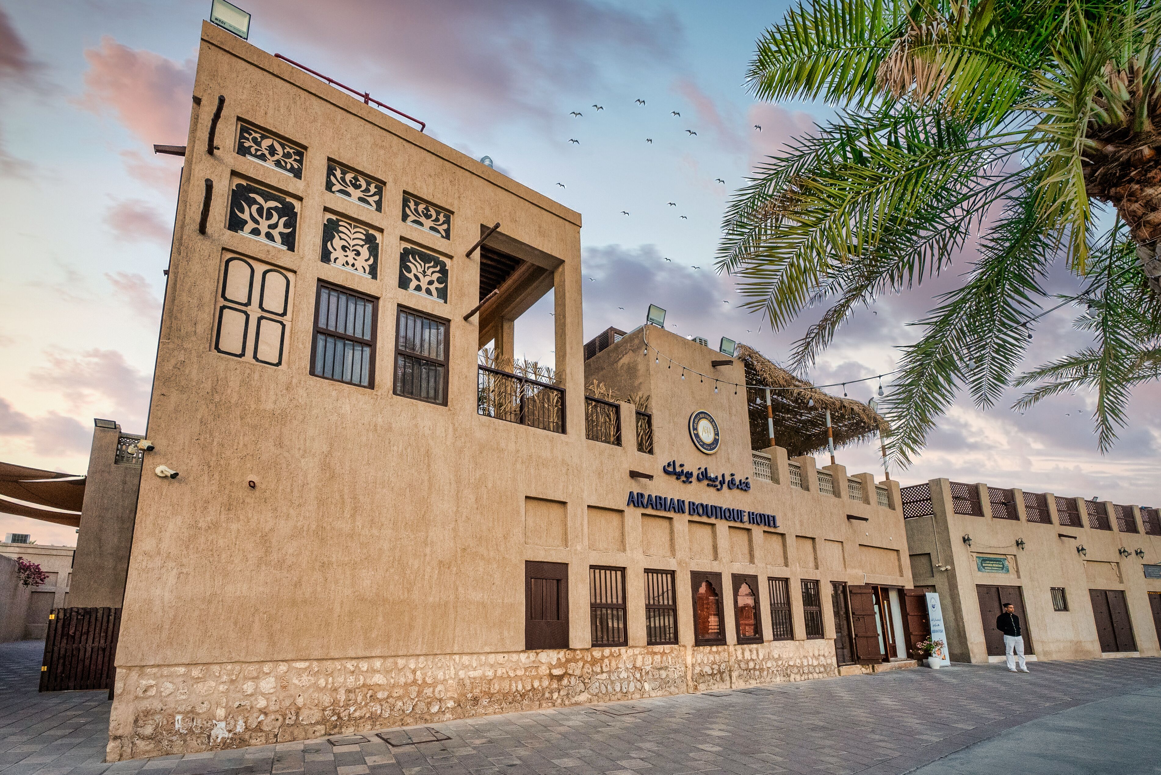 A building with a sign reading "Arabian Boutique Hotel".