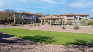 A residential complex with multiple houses, a covered patio area, and a well-maintained lawn. - Perfect for long-term stay, heated Pool, Spa, Gym  (Oro Valley)