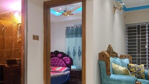 A room with a bed, a sofa, and a ceiling fan. - Stunning 1-bed Apartment in Dhaka Close to Airport (Dhaka)