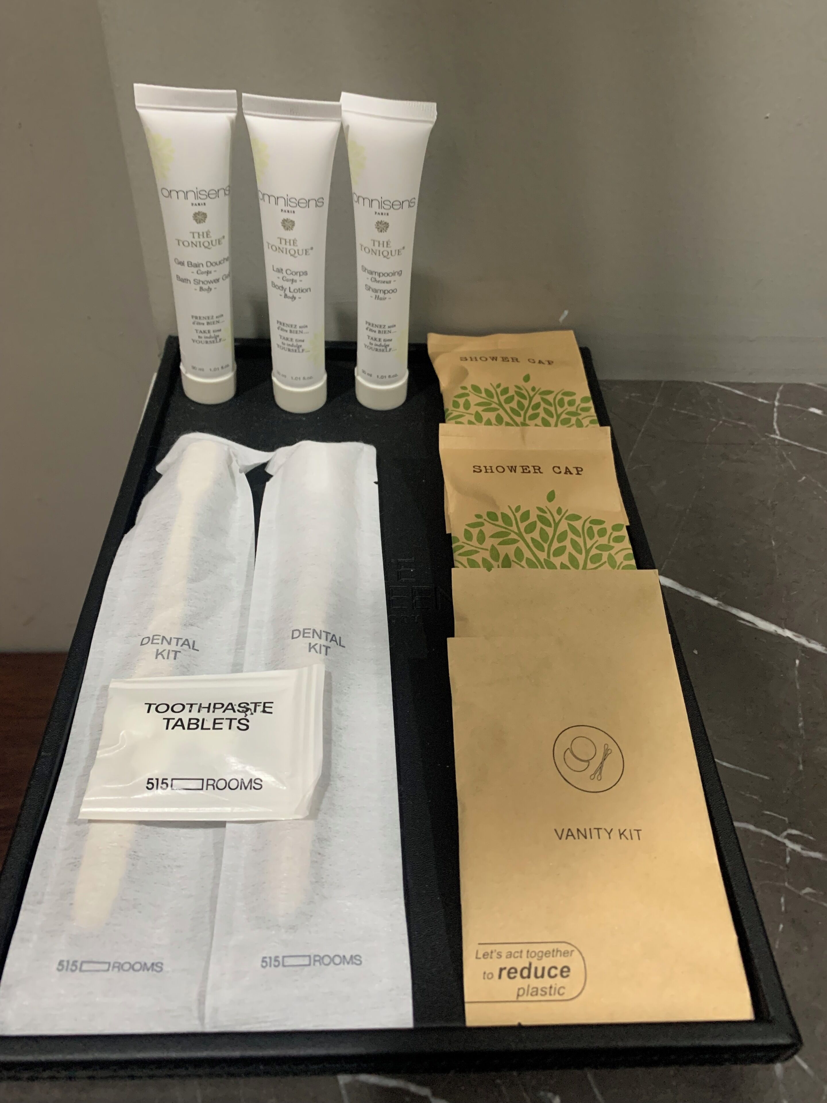 Toiletries and a dental kit in a hotel room.
