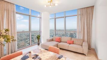 Deluxe Penthouse | Living area | 65-inch Smart TV with cable channels, TV