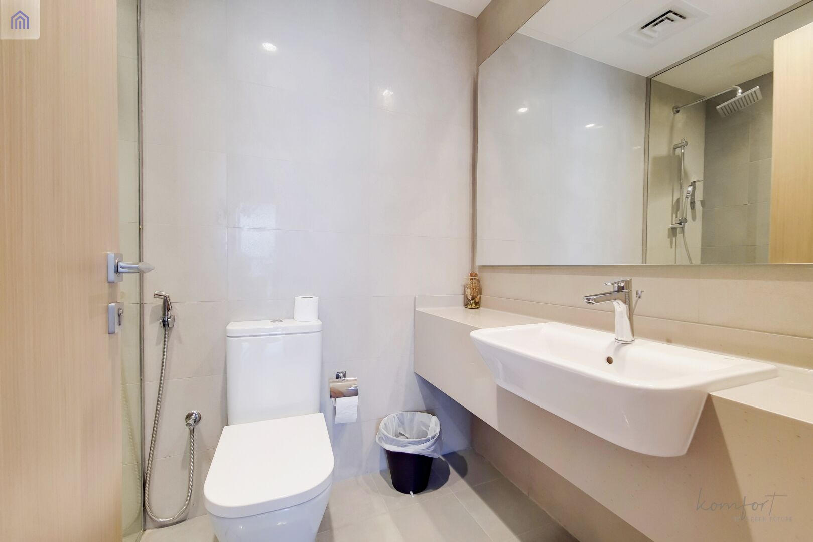 A modern bathroom with a toilet, bidet, and sink.