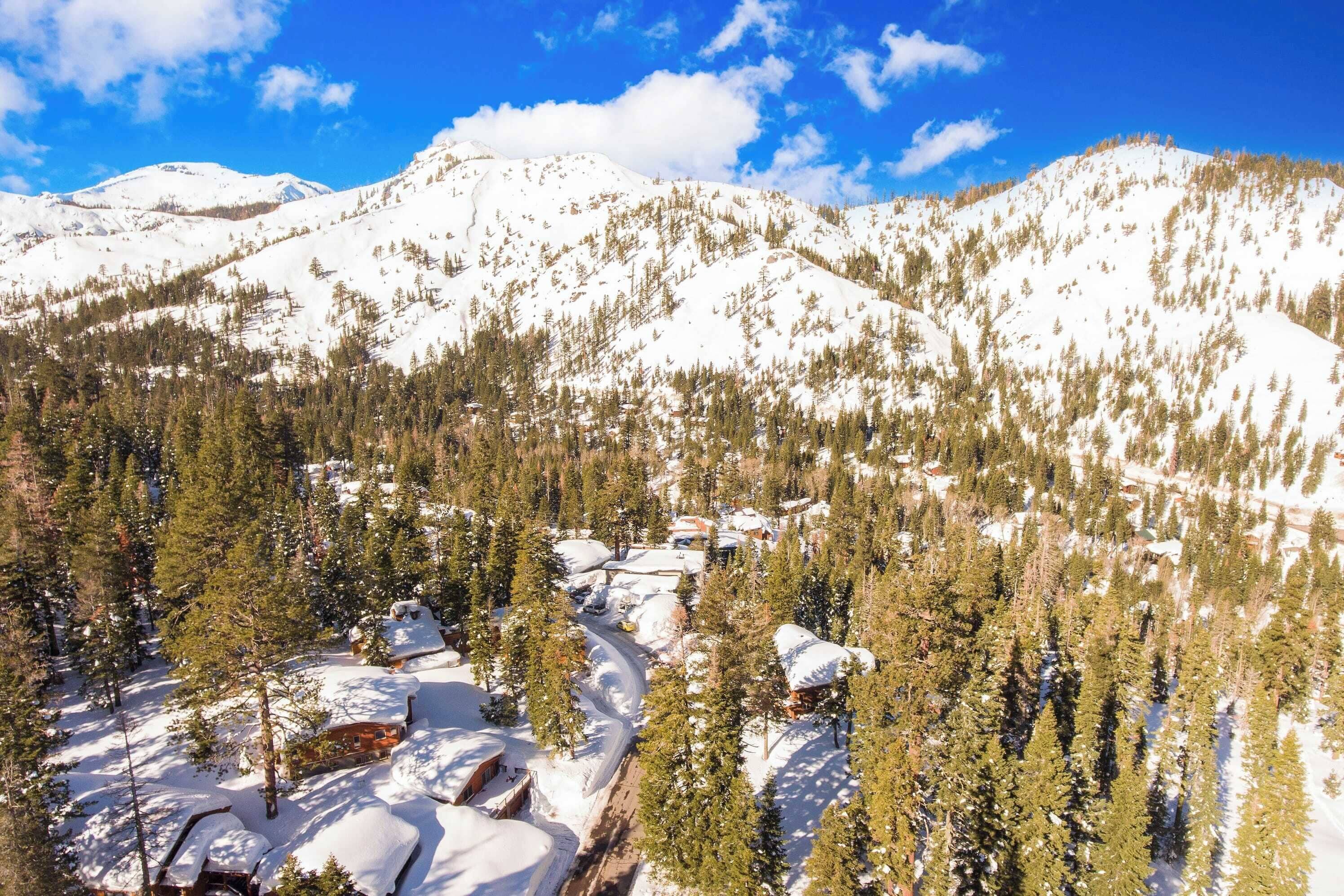 A snow-covered mountain landscape with a ski resort.