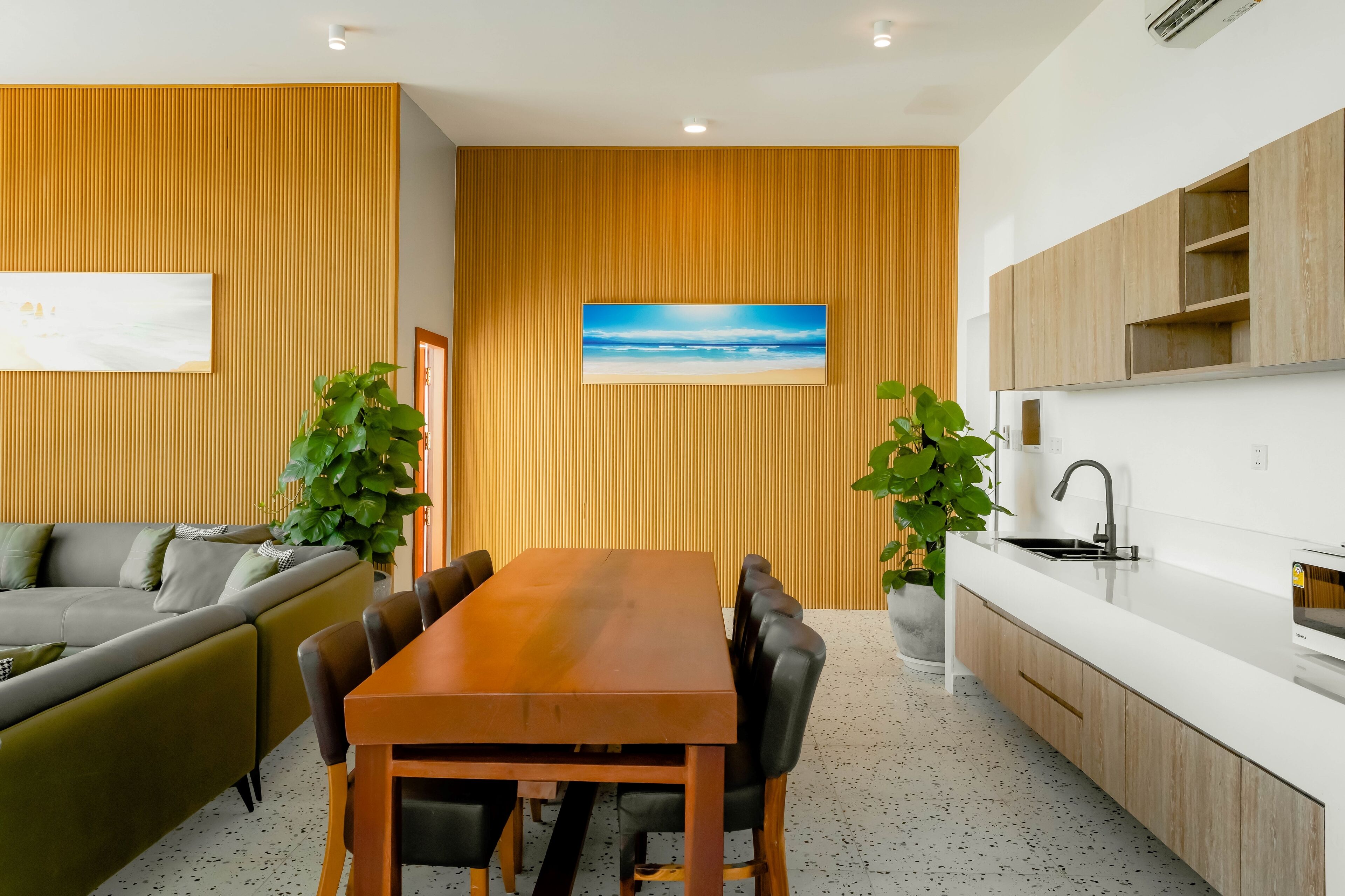 A modern kitchen with wooden cabinets, a white countertop, and a built-in sink.