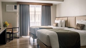 A hotel room with two beds, a desk, and a chair. - Canyon Hotels & Resorts Boracay (Boracay Island)