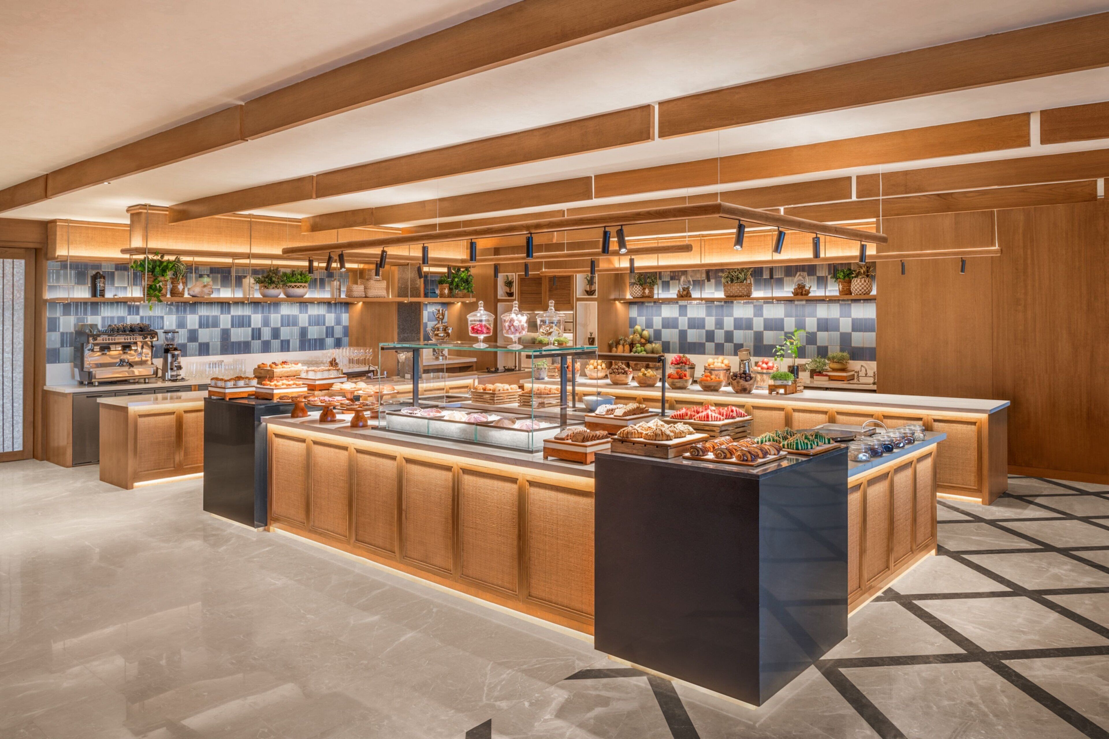 A modern kitchen with a central island, wooden cabinets, and a tiled backsplash.