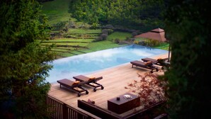 A wooden deck with lounge chairs and a small pool, surrounded by greenery and a hilly landscape. - Rissai Valley, a Ritz-Carlton Reserve (Ngawa Autonomous Prefecture)