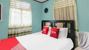A neatly made bed with white and red bedding, a headboard, and two pillows with the word "OYO" on them. - OYO Homes 91148 Homesstay Desa Wisata Bahoi Near Ekowisata Mangrove Desa Bahoi (Bahoi)