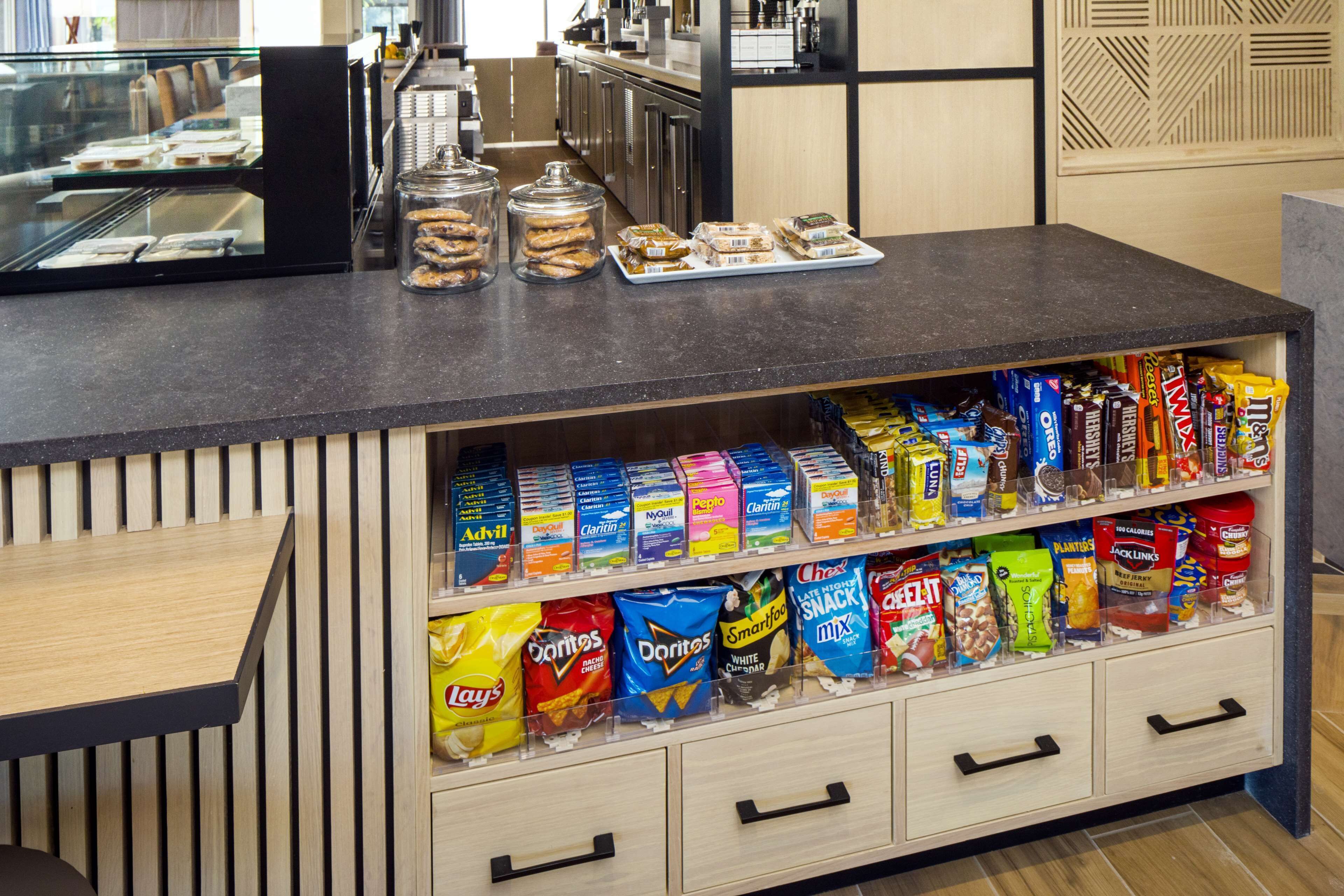 A snack display with various chips and cookies.
