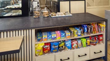 A snack display with various chips and cookies.