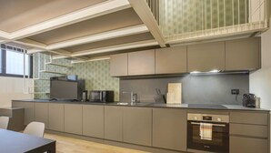 A modern kitchen with a built-in oven, microwave, and sink. - Modern Loft in Porta Venezia (Milan)