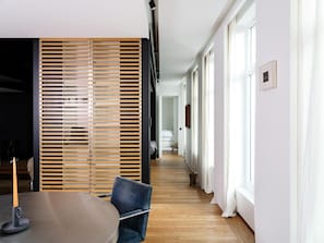 Experience a clean and contemporary space with a minimalist design, featuring a round table and a single chair.