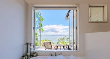 Koi Waiheke - Koi Waiheke is a stunning luxury holiday home in Omiha, Waiheke Island. With 4 bedrooms; 4 bathrooms; a large entertainer’s kitchen; spectacular ocean views; a private mooring; and a boat shed offering direct access to the ocean. This i