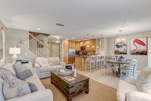 Relax in this inviting living area with a sofa set, coffee table, and dining space.