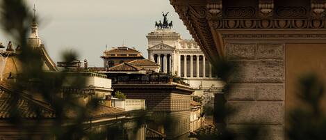 A classical building with ornate columns and a statue on top.