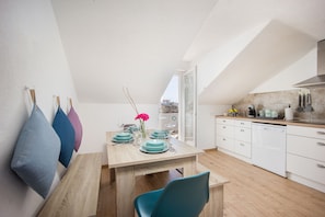 Enjoy meals in the kitchen and dining area with a view of the city.