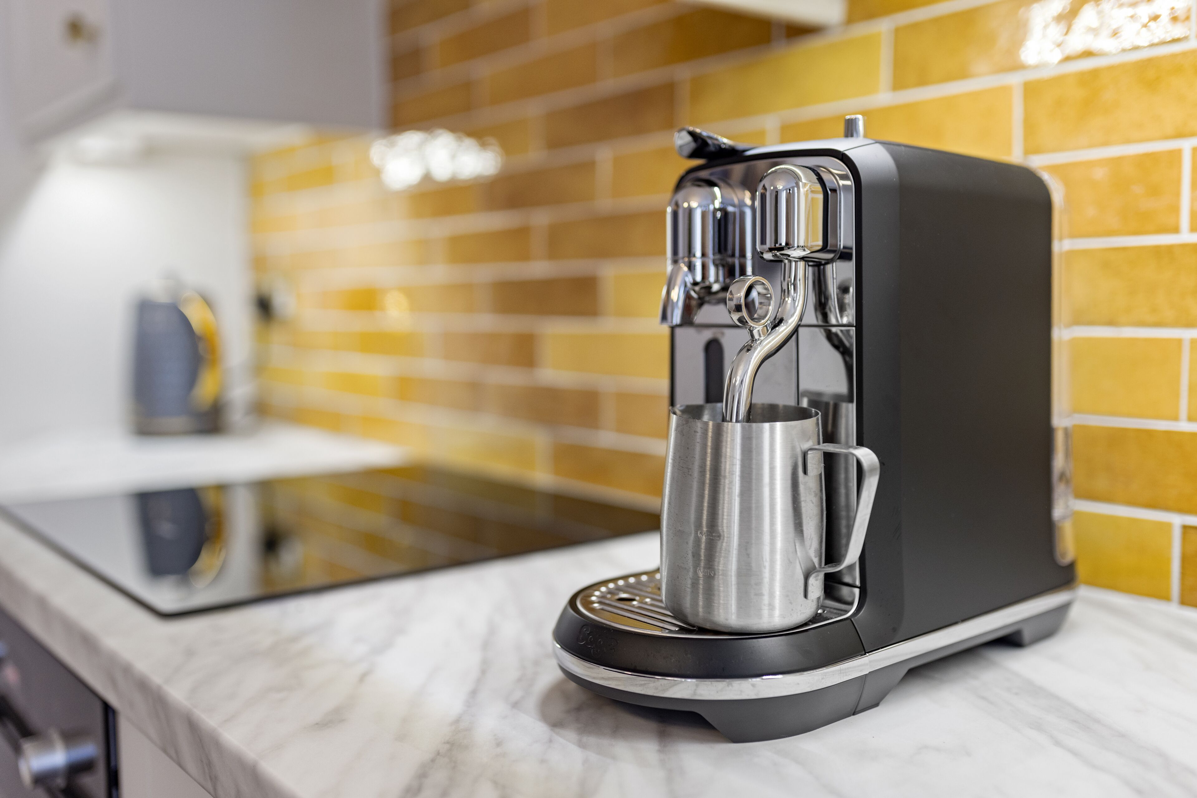 espresso maker, coffee/tea maker, electric kettle, dining tables