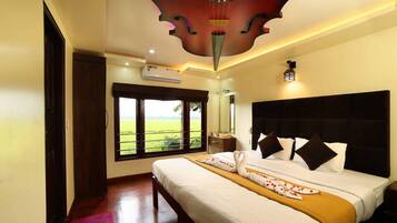 A hotel room with a large bed, a window with a view of the countryside, and a ceiling with a unique design.