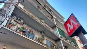 A multi-story building with balconies, some with plants. - 4bnb - Cozy Albornoz Flat (Rome)