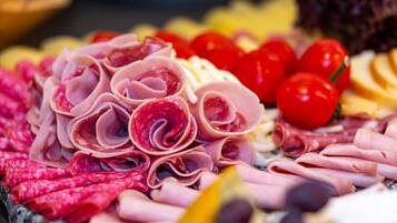 A variety of sliced meats and cheeses arranged on a platter.