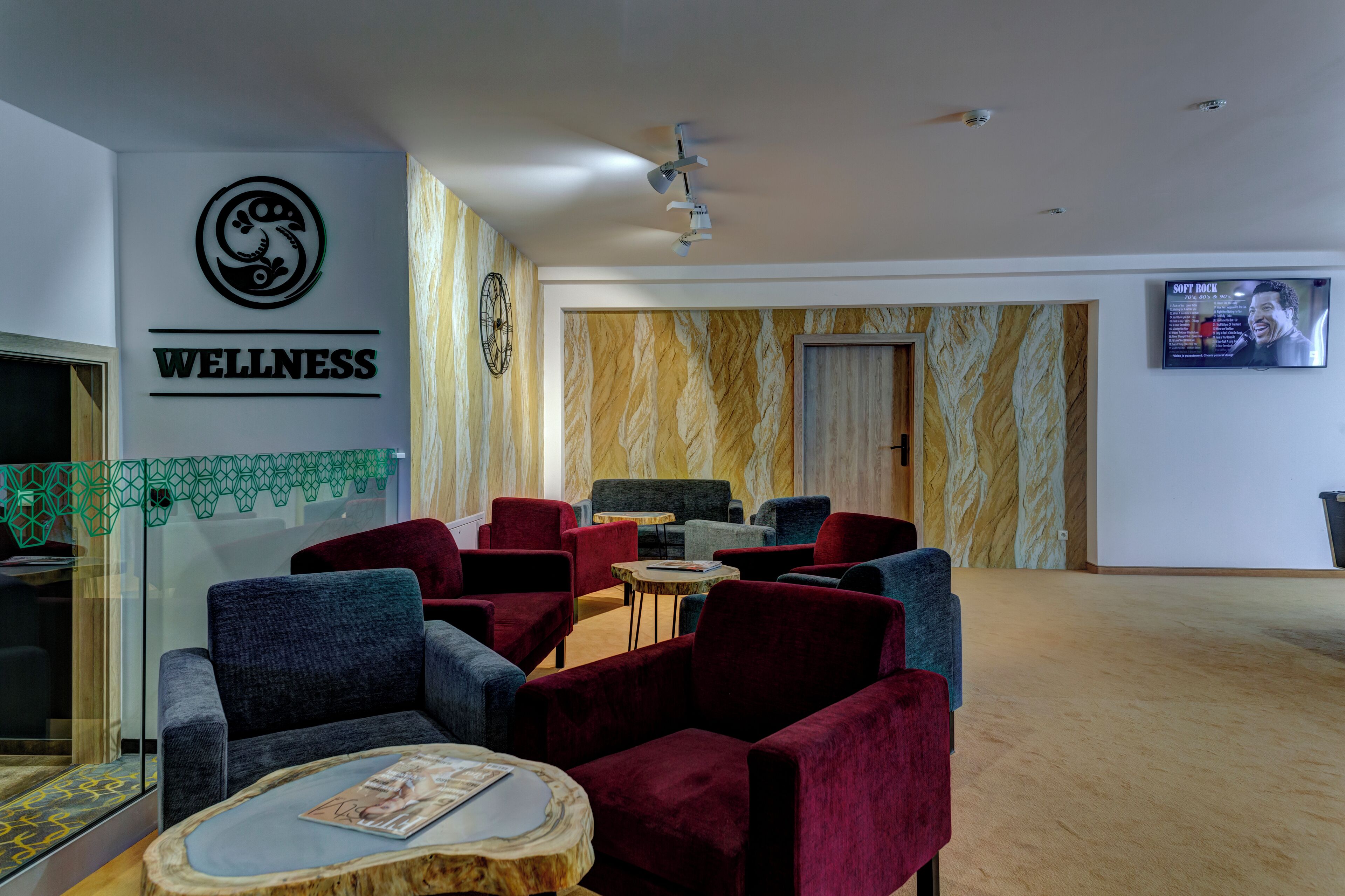 A wellness center with a reception area, seating, and a television screen.