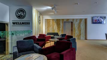 A wellness center with a reception area, seating, and a television screen.