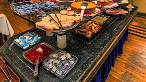 A buffet with various food items including cakes, pastries, and fruits. - Palace Hotel de Caxambu (Caxambu)