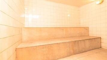 Bathroom features a shower area with beige steps.