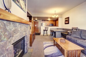 Cozy living space with a fireplace, seating area, and kitchen.