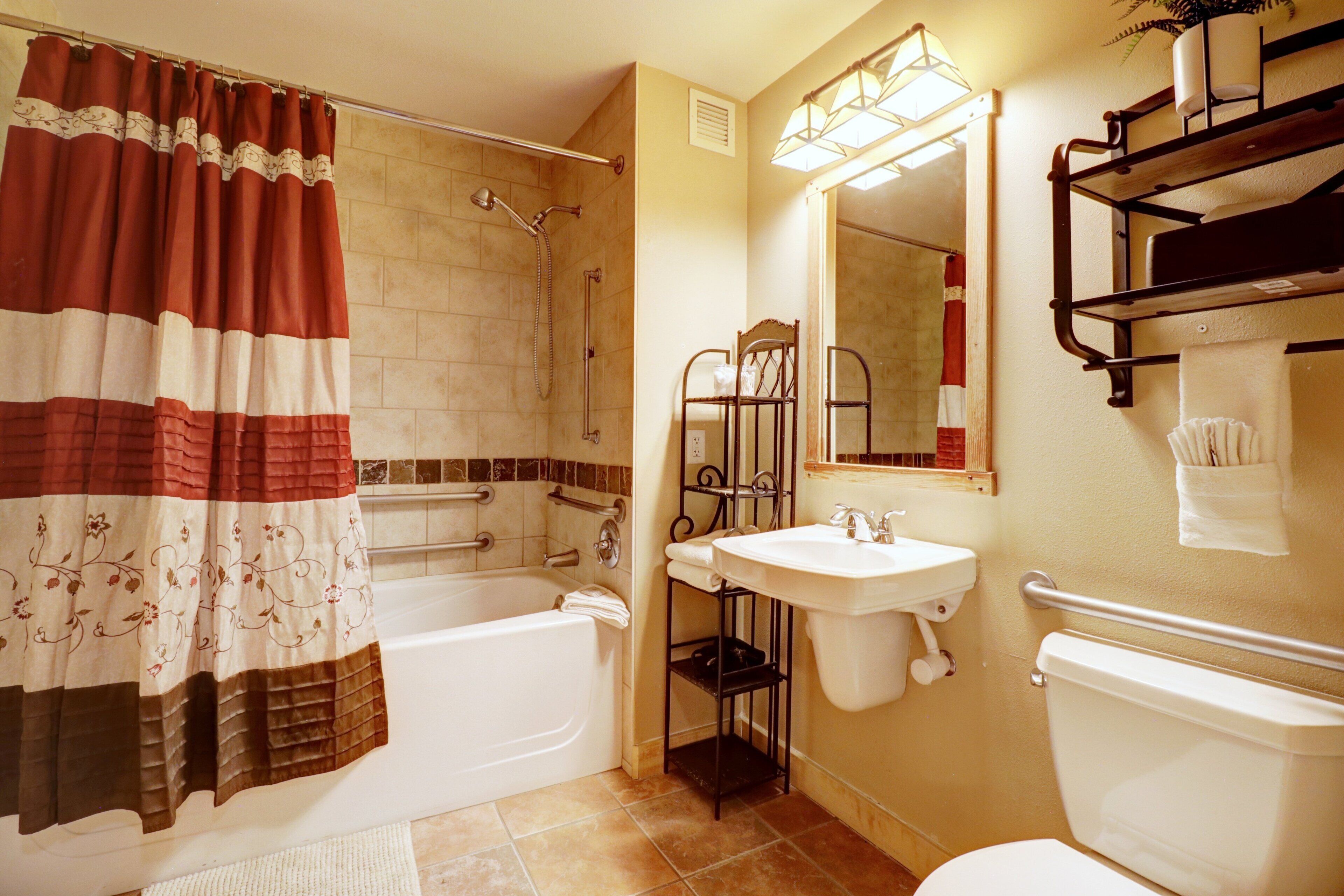 A bathroom with a bathtub, a sink, and a toilet.