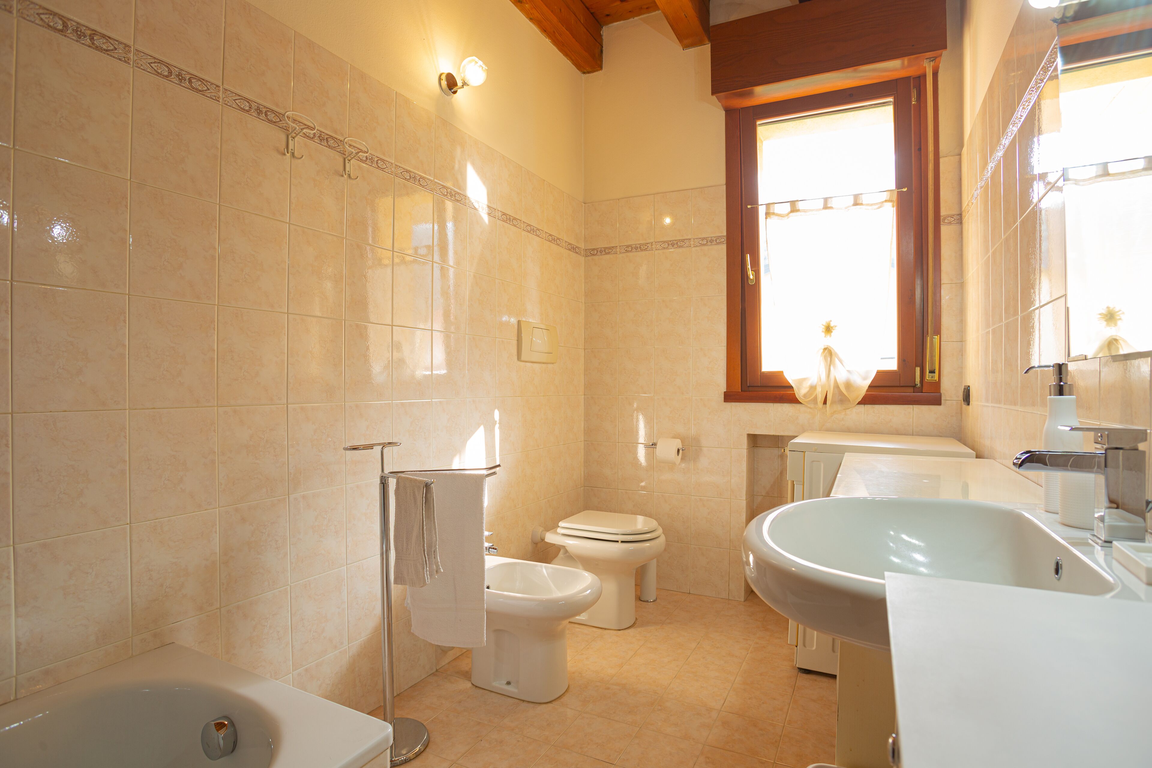 A bathroom with a bathtub, a sink, and a toilet.