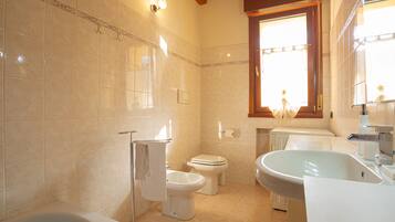 A bathroom with a bathtub, a sink, and a toilet.