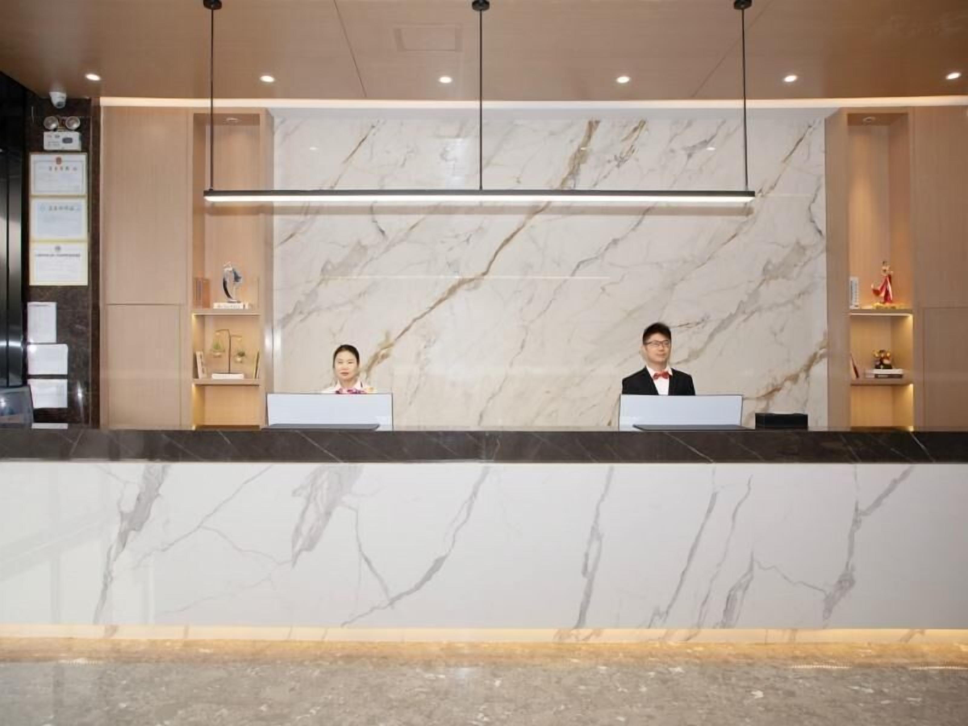 Ein Hotelrezeptionstresen mit Marmorwänden und modernem Design.