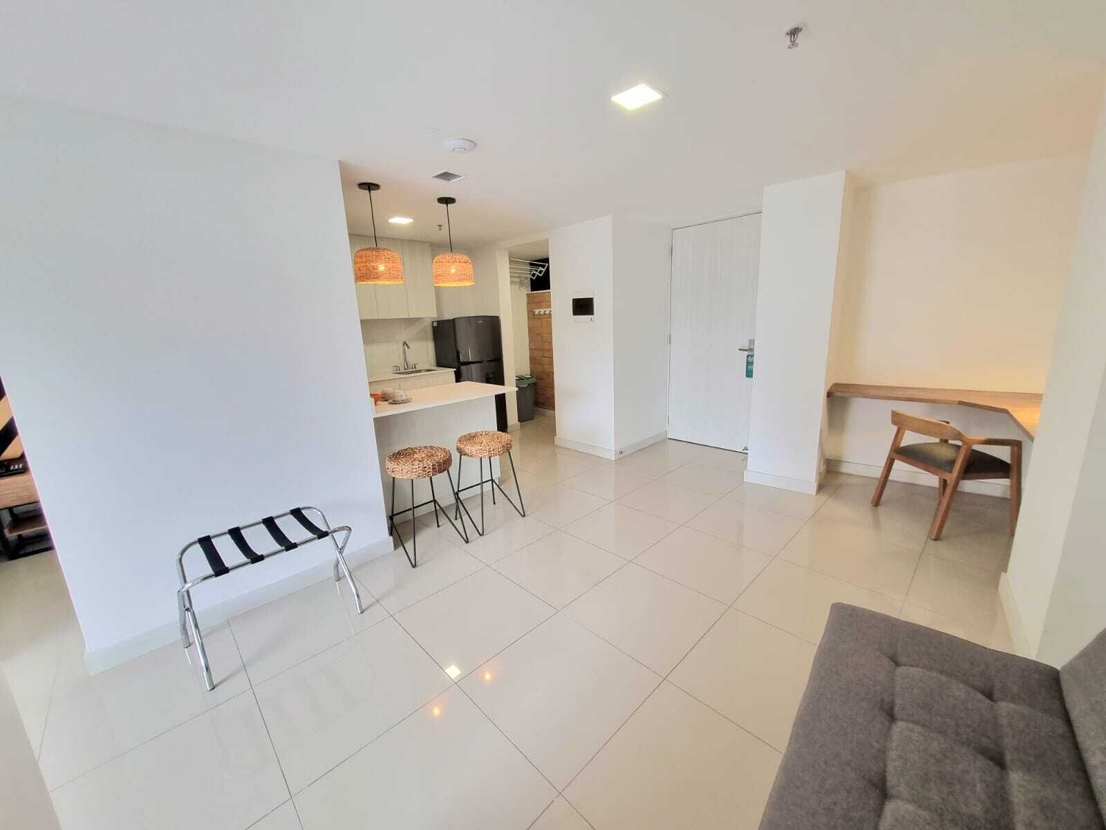A modern apartment with a kitchen, dining area, and living room.
