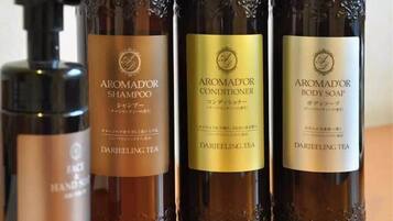 Drie flessen producten op basis van Darjeeling thee: shampoo, conditioner en douchezeep.