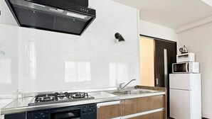 Eine moderne Küche mit Gasherd, Backofen und Mikrowelle.