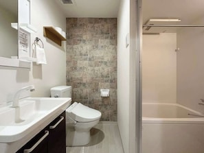 Bathtub, hair dryer, towels, soap