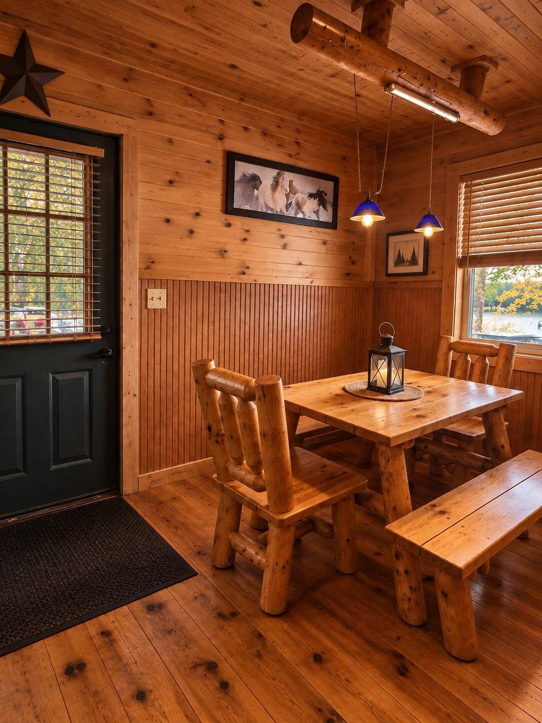 A wooden interior with a dining table, benches, and a star decoration on the wall.
