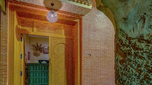 An ornate entrance with intricate woodwork and a hanging light fixture. - Deluxe Room #8 (Marrakech)