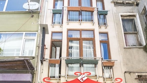 A building with a red sign reading "KOÇAK PENSION" and a welcome message. - Koçak Pansiyon (Istanbul)