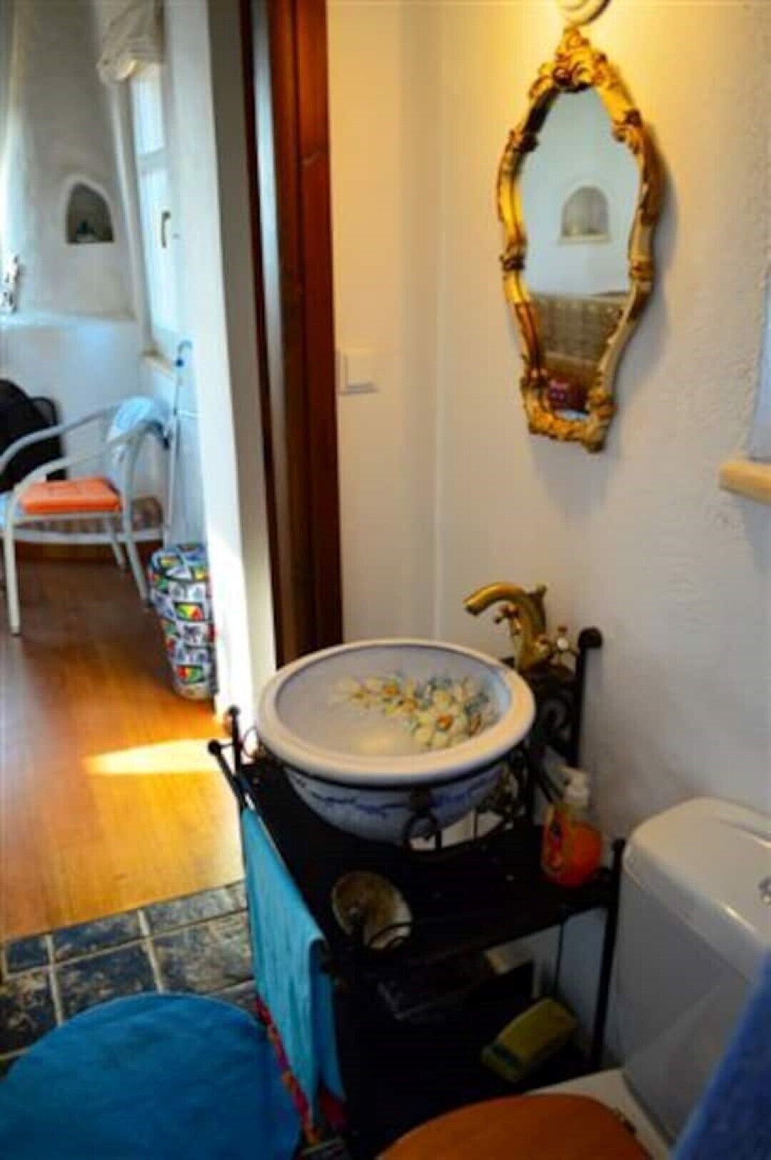 A bathroom with a white sink, a mirror, and a toilet.
