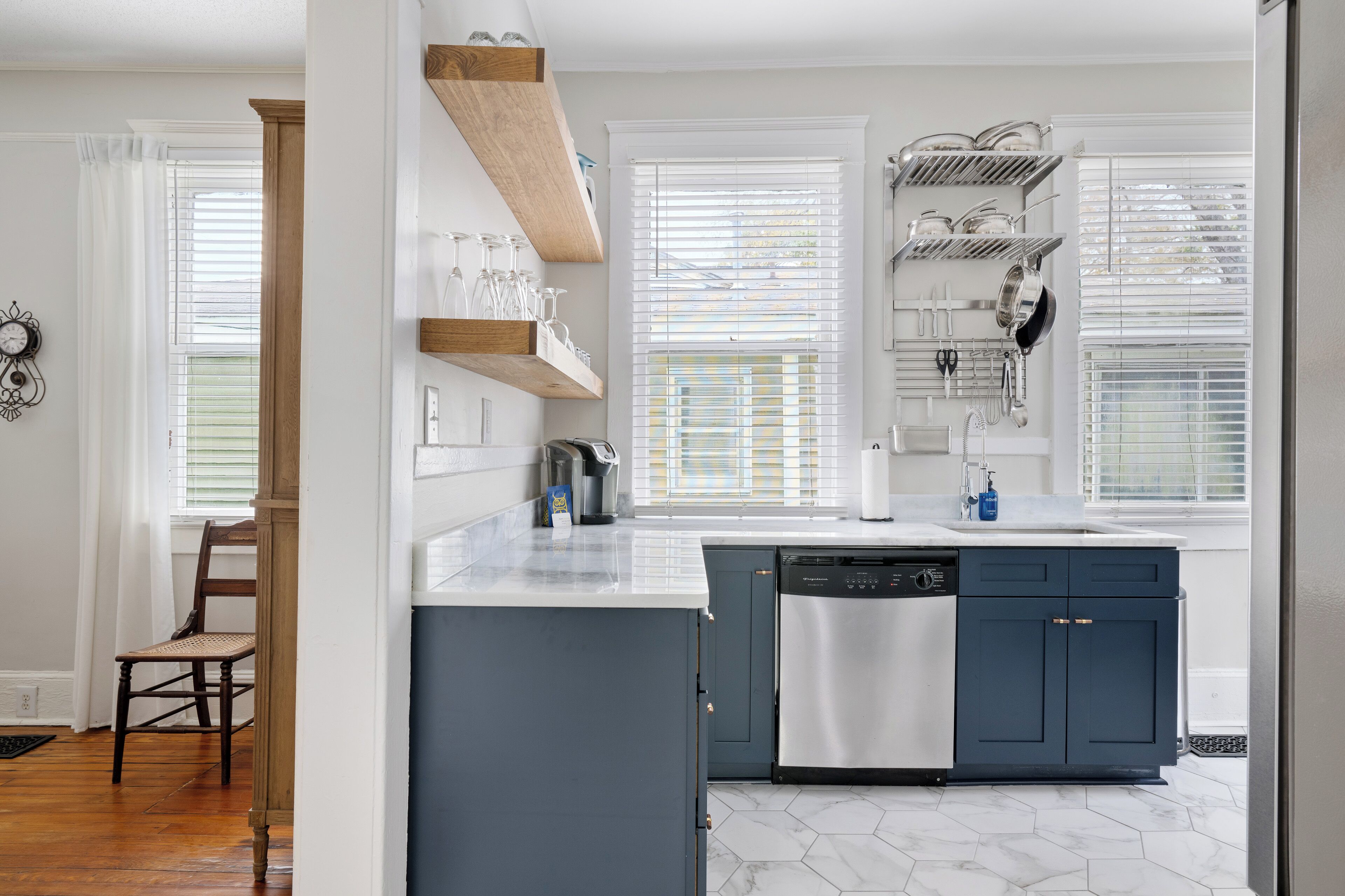 A modern kitchen with a central island, built-in appliances, and ample natural light.