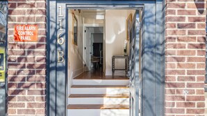 A fire alarm control panel sign, a staircase leading to a room, and a door with the number 116B. - The Feather | Next To Bad Bunnies Coffee (Charleston)