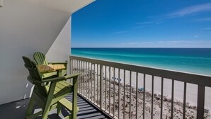 A balcony with a view of a beach and ocean. - Pelican Beach 0710 1 Bedroom Condo by Pelican Beach Management (Destin)