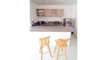 Fridge, blender, cookware/dishes/utensils, dining tables