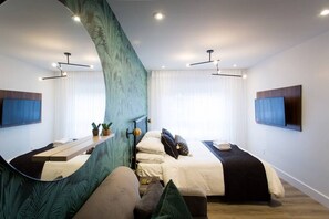 Une chambre d’hôtel moderne dotée de deux lits, d’un grand miroir, d’un téléviseur à écran plat et d’un décor mural vert original.