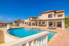 A resort with a large swimming pool, multiple villas, and a well-maintained garden. - Villa with private pool with endless views. January 2027 availability! (Noord)