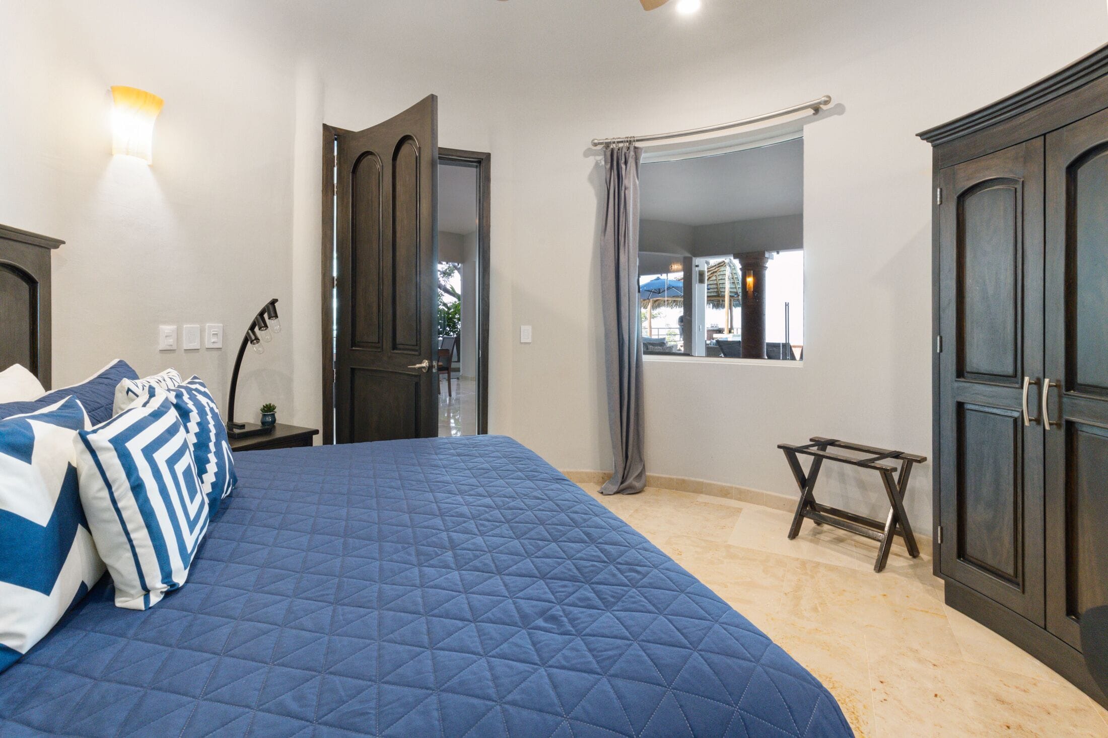 "David" Blue King Bedroom with view to patio area.
