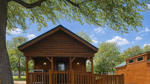 A wooden cabin with a porch and a covered deck area. - Beautiful Log cabin overlooking a meadow (Pipe Creek)